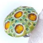 Green and yellow ring, cera..
