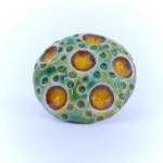 Green and yellow ring, cera..